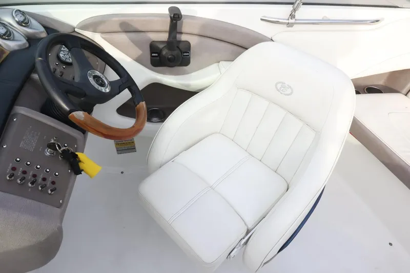 Slide: The Image of Cobalt 200 boat interior, 2005 model, featuring steering wheel and white captain's chair. - 28