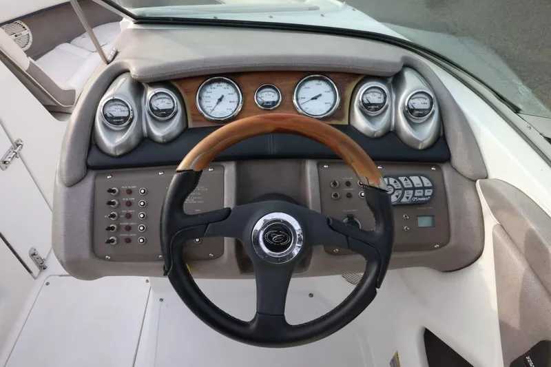 Slide: The Image of Steering wheel and dashboard of 2005 Cobalt 200 boat with gauges and controls. - 30