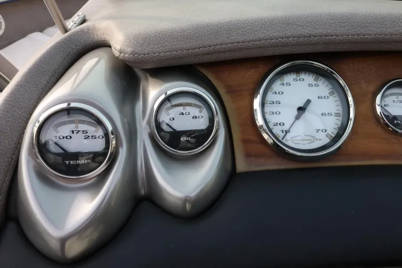Slide: The Image of Dashboard gauges of a 2005 Cobalt 200 boat, showing temperature, oil, and speedometer. - 32