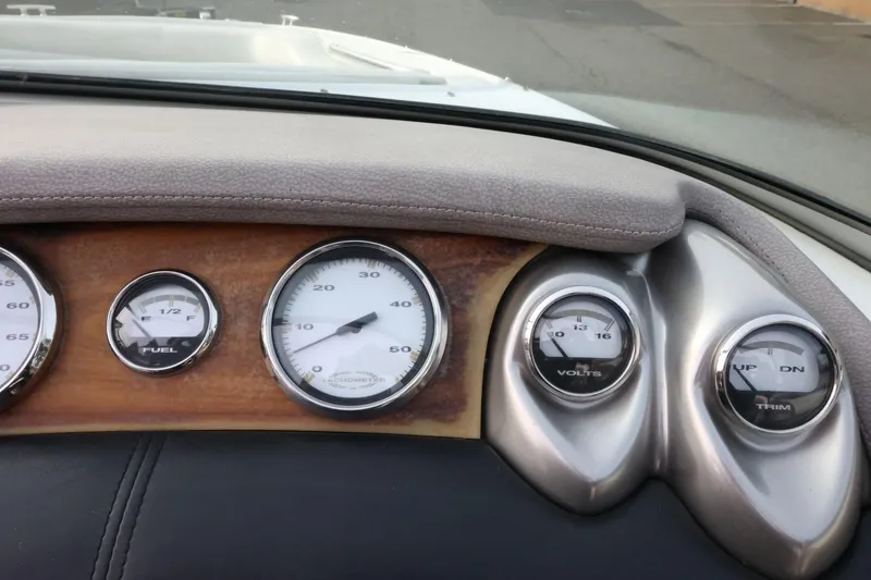 Slide: The Image of Dashboard of a 2005 Cobalt 200 boat with fuel, speed, volts, and trim gauges. - 34
