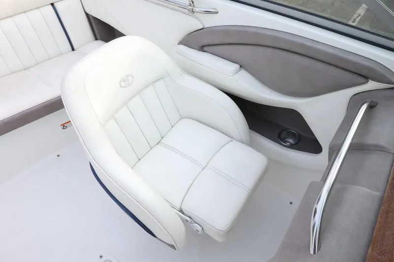 Slide: The Image of 2005 Cobalt 200 boat interior with white and gray seating. - 35