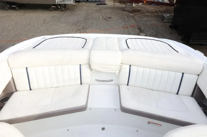 Slide: The Image of 2005 Cobalt 200 boat interior with white cushioned seating. - 39