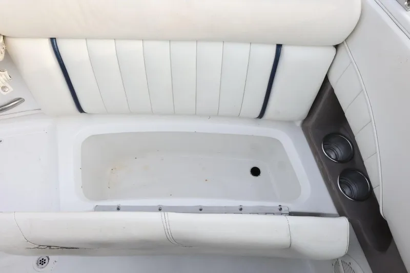 Slide: The Image of White seating area with cup holders on a 2005 Cobalt 200 boat. - 41