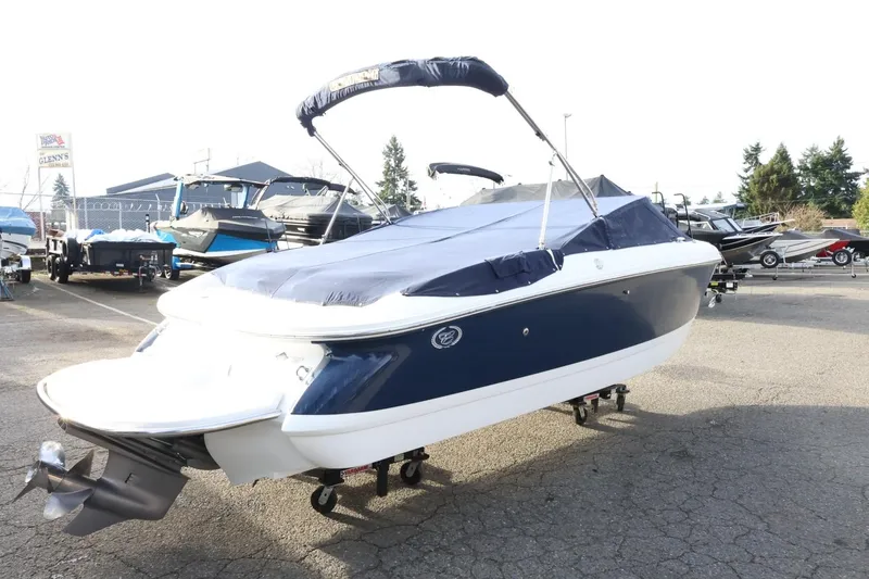 Slide: The Image of 2005 Cobalt 200 boat with cover in a marina parking lot. - 46