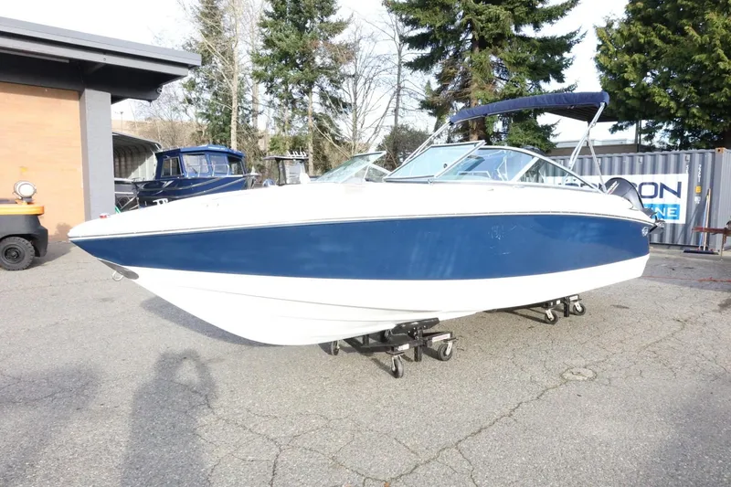 Slide: The Image of 2005 Cobalt 200 boat with blue and white hull on a trailer. - 5