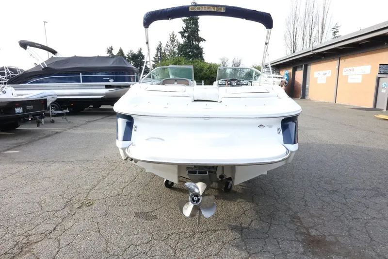 Slide: The Image of 2005 Cobalt 200 boat, rear view, parked outdoors on a paved surface. - 8