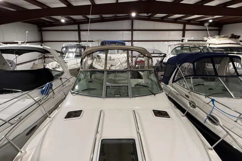 Slide: The Image of 2000 Sea Ray Sundancer 310 yacht in indoor storage, surrounded by other boats. - 10