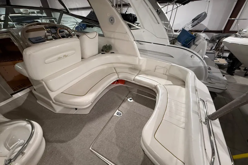 Slide: The Image of 2000 Sea Ray Sundancer 310 interior with white seating and helm, showcasing luxury design. - 12