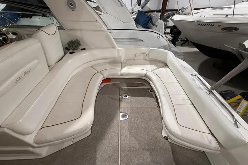 Slide: The Image of Luxurious seating area on a 2000 Sea Ray Sundancer 310 boat, featuring white upholstery. - 13