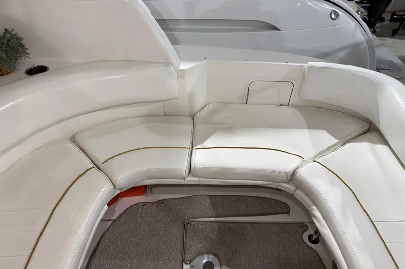 Slide: The Image of 2000 Sea Ray Sundancer 310 interior seating with white upholstery and curved design. - 16