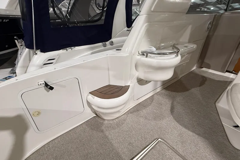 Slide: The Image of 2000 Sea Ray Sundancer 310 interior with seating and cup holder, featuring sleek design elements. - 20