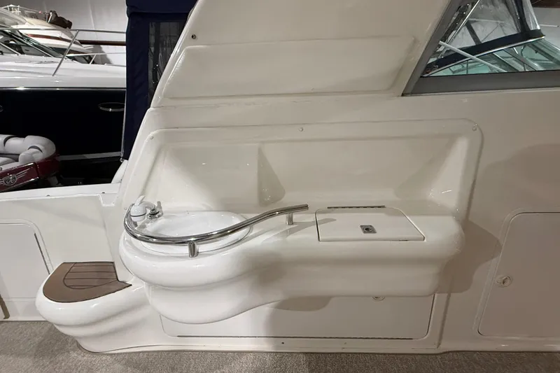 Slide: The Image of 2000 Sea Ray Sundancer 310 boat interior with sink and seating area. - 21