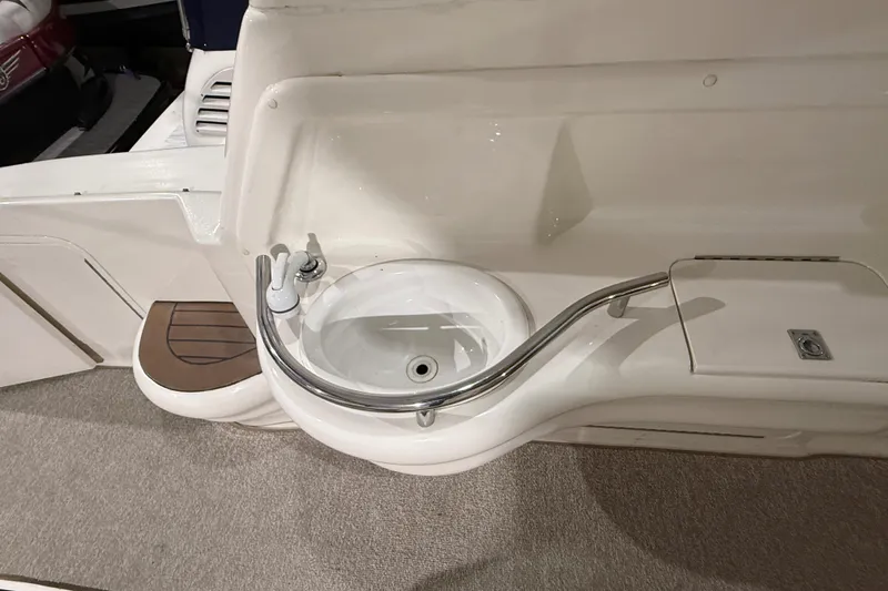 Slide: The Image of 2000 Sea Ray Sundancer 310 boat sink with curved faucet and white basin. - 22