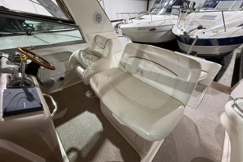 Slide: The Image of Interior of a 2000 Sea Ray Sundancer 310 boat with plush seating and steering wheel. - 25