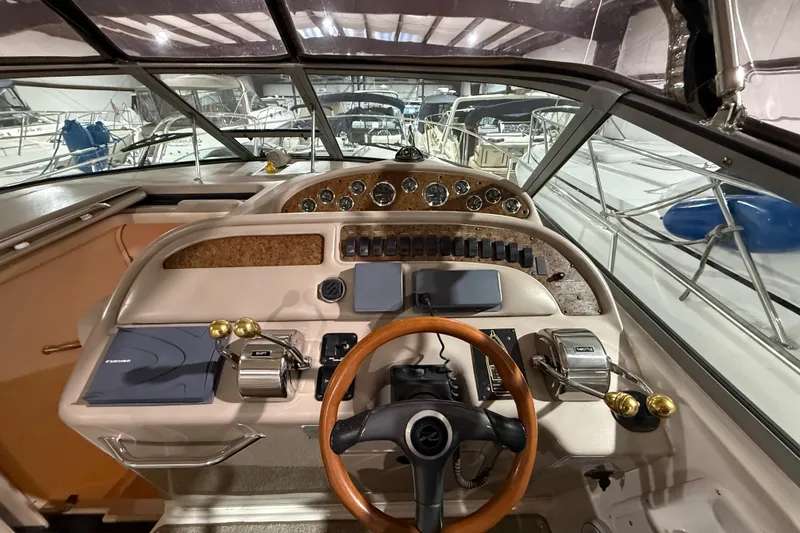 Slide: The Image of Cockpit of 2000 Sea Ray Sundancer 310 with steering wheel and control panel. - 27
