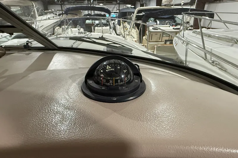 Slide: The Image of Compass on 2000 Sea Ray Sundancer 310 dashboard in marina setting. - 31