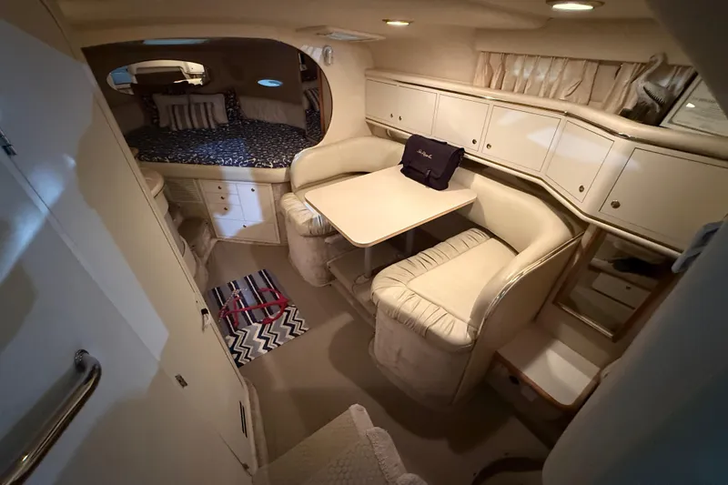 Slide: The Image of Interior of 2000 Sea Ray Sundancer 310 with cozy seating and sleeping area. - 35