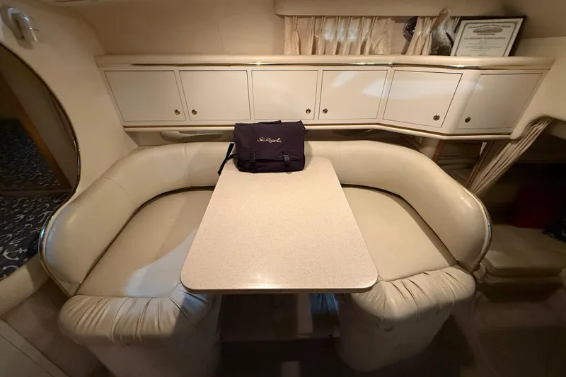 Slide: The Image of 2000 Sea Ray Sundancer 310 cabin interior with dining area and storage cabinets. - 36