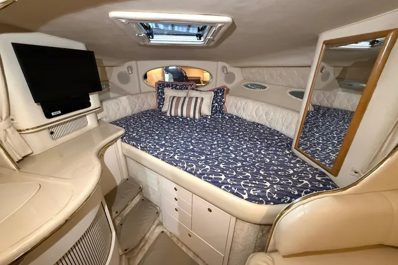 Slide: The Image of Luxurious cabin interior of 2000 Sea Ray Sundancer 310 with cozy bed and TV. - 39