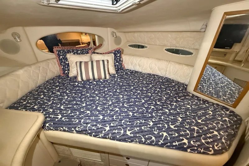 Slide: The Image of Cozy cabin interior of 2000 Sea Ray Sundancer 310 with nautical-themed bedding. - 41