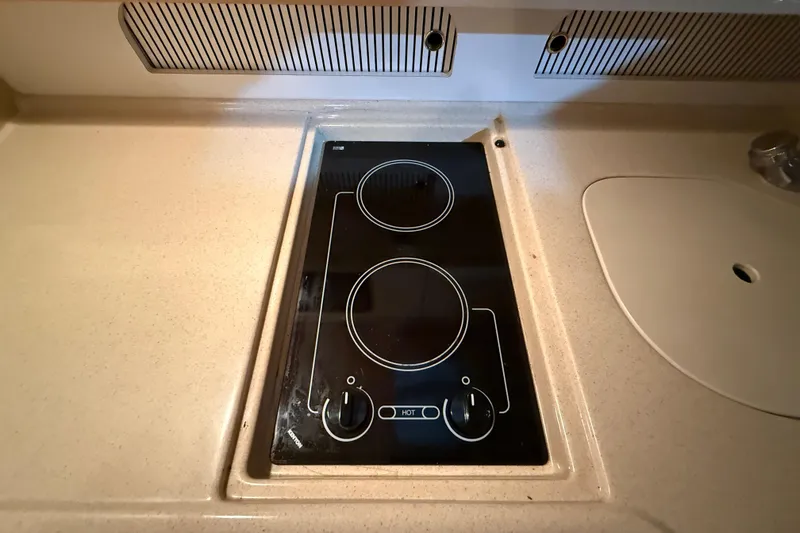 Slide: The Image of Stovetop in 2000 Sea Ray Sundancer 310 yacht kitchen, featuring dual burners. - 47