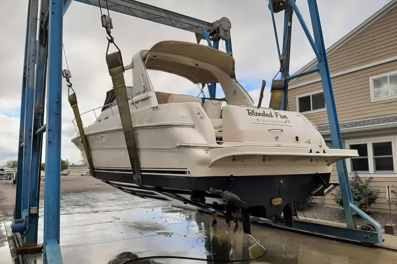 Slide: The Image of 2000 Sea Ray 310 Sundancer boat lifted on a dockside hoist. - 5