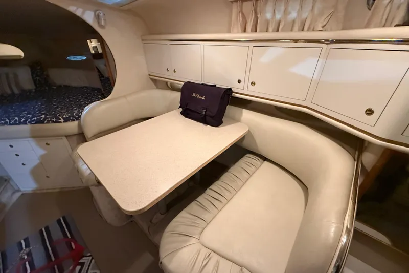 Slide: The Image of Interior of 2000 Sea Ray Sundancer 310 with cozy seating and table. - 52