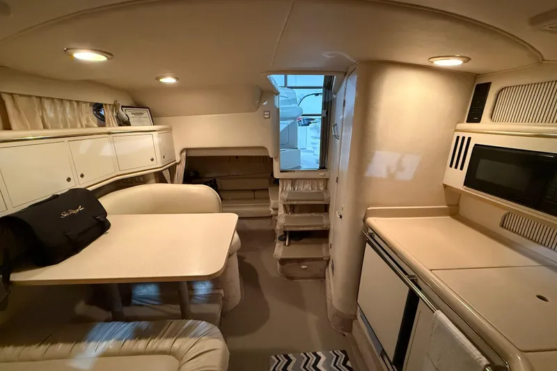 Slide: The Image of Interior of 2000 Sea Ray Sundancer 310 yacht with kitchenette and seating area. - 53