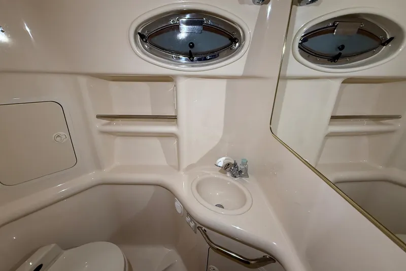 Slide: The Image of Bathroom interior of 2000 Sea Ray Sundancer 310 yacht with sink and porthole window. - 55