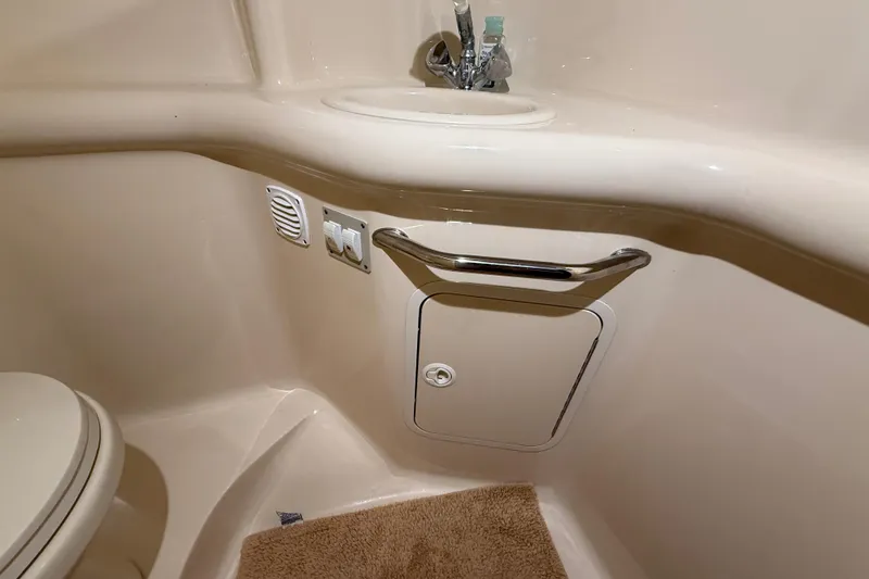 Slide: The Image of Interior of 2000 Sea Ray Sundancer 310 bathroom with sink and storage. - 56