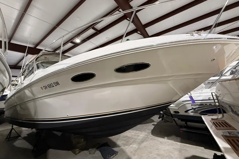 Slide: The Image of 2000 Sea Ray Sundancer 310 boat in indoor storage, side view. - 63