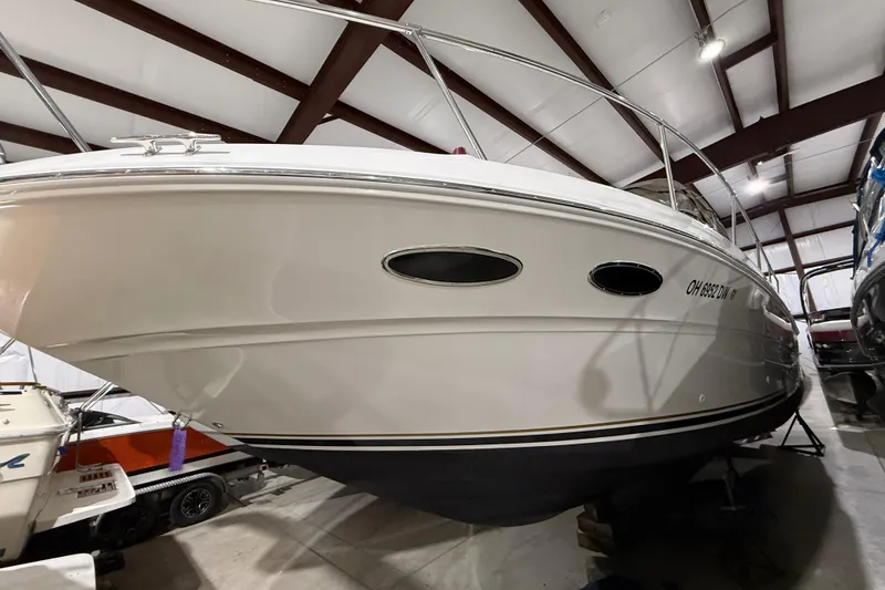 Slide: The Image of 2000 Sea Ray Sundancer 310 boat in indoor storage facility. - 64