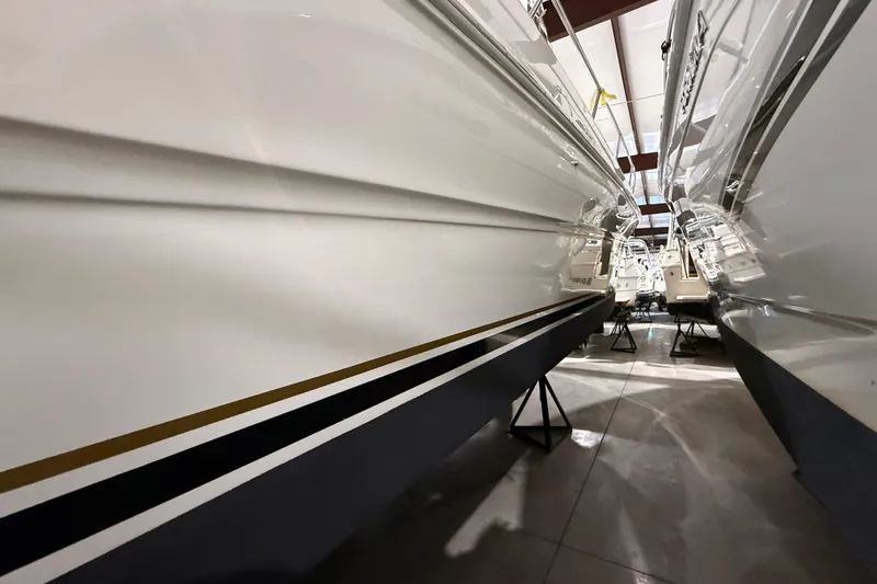 Slide: The Image of 2000 Sea Ray Sundancer 310 boats in storage, side view, indoor facility. - 66