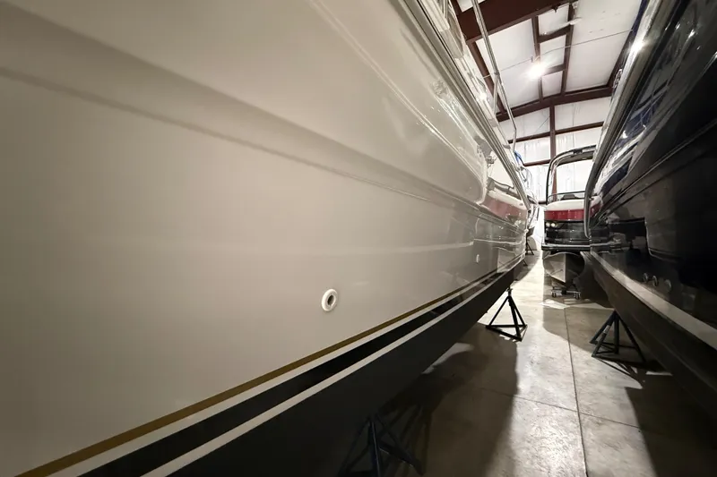 Slide: The Image of 2000 Sea Ray Sundancer 310 yacht in storage, side view in a warehouse. - 67