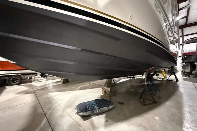 Slide: The Image of 2000 Sea Ray Sundancer 310 boat in indoor storage on stands. - 68