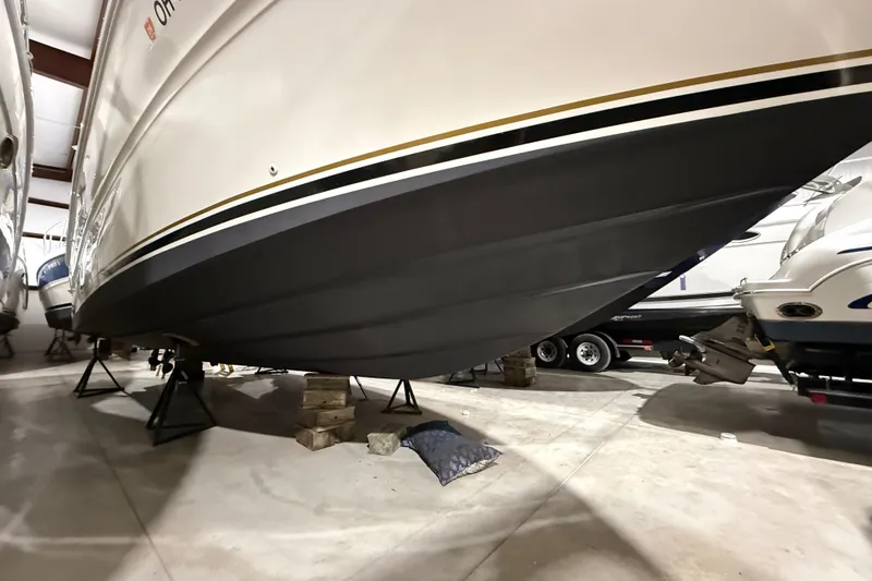 Slide: The Image of 2000 Sea Ray Sundancer 310 boat in storage, supported by stands and blocks. - 69