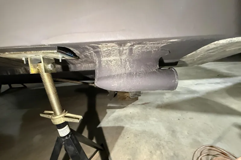 Slide: The Image of 2000 Sea Ray Sundancer 310 hull detail with support jack in garage. - 73