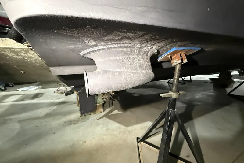 Slide: The Image of 2000 Sea Ray Sundancer 310 boat hull on a stand in a garage. - 74