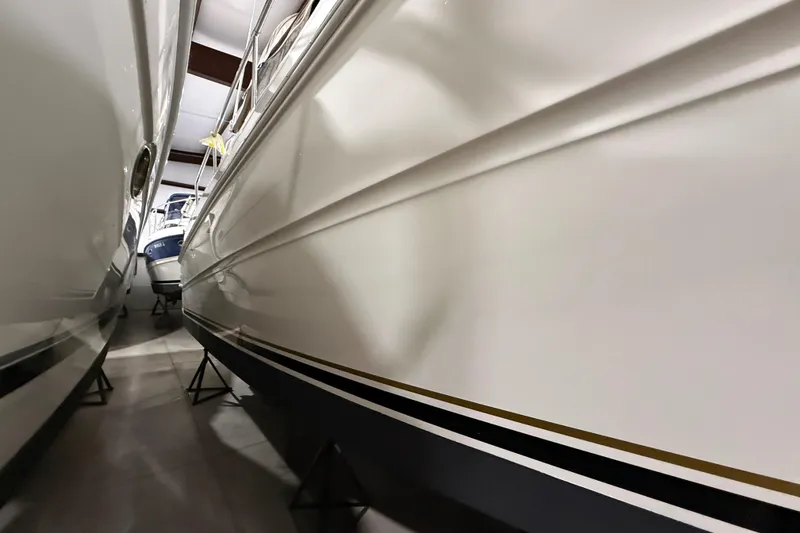 Slide: The Image of 2000 Sea Ray Sundancer 310 yacht in storage, side view, indoors. - 75