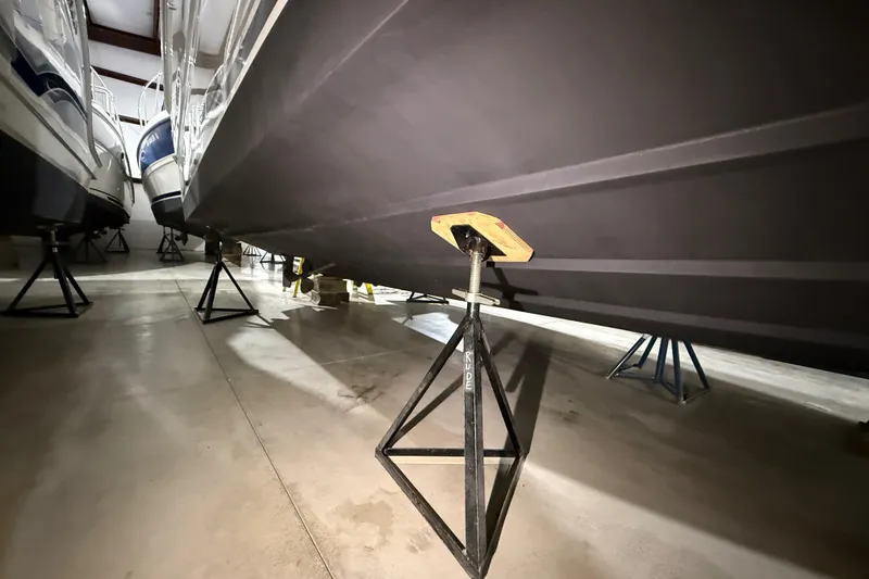 Slide: The Image of 2000 Sea Ray Sundancer 310 boat in storage, supported by stands. - 76