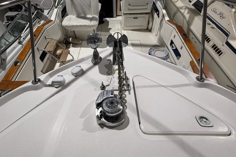 Slide: The Image of Sea Ray Sundancer 310 boat deck, featuring anchor chain and seating, year 2000 model. - 9