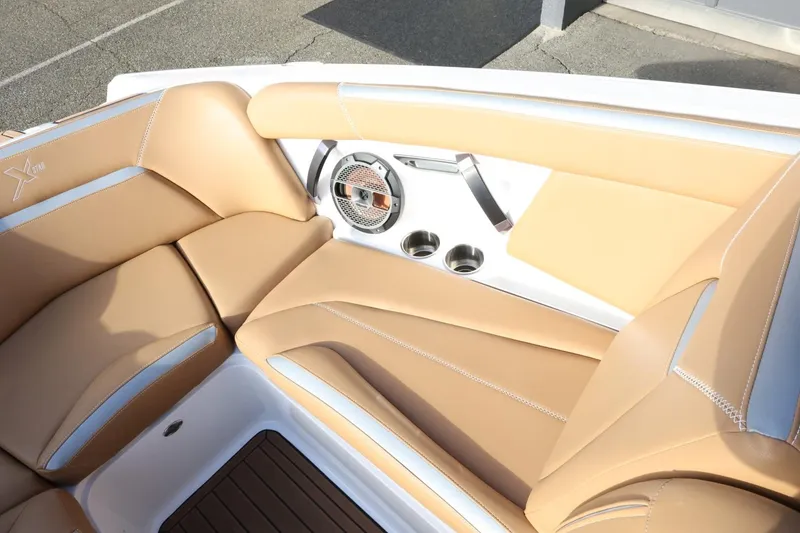 Slide: The Image of 2020 MasterCraft XStar boat interior with tan leather seats and speaker system. - 19