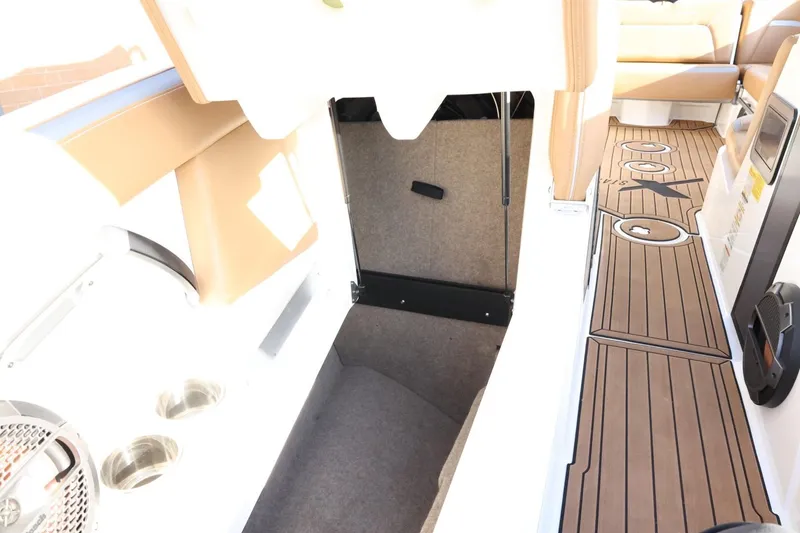Slide: The Image of 2020 MasterCraft XStar interior with tan seating, wood-style flooring, and storage compartment. - 24