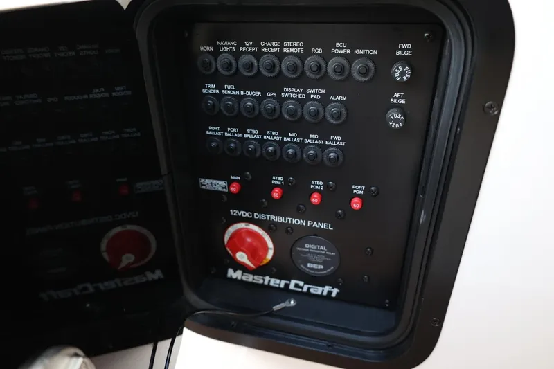 Slide: The Image of 2020 MasterCraft XStar 12VDC distribution panel with various switches and controls. - 29