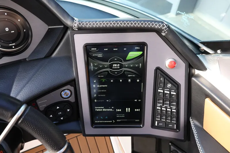 Slide: The Image of 2020 MasterCraft XStar dashboard with touchscreen controls and navigation system. - 32