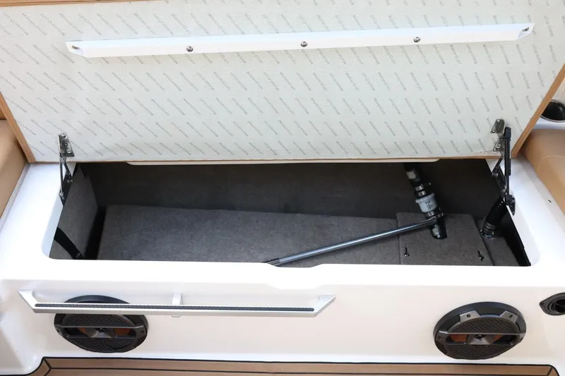 Slide: The Image of Open storage compartment in 2020 MasterCraft XStar boat, featuring speakers and hydraulic support. - 47