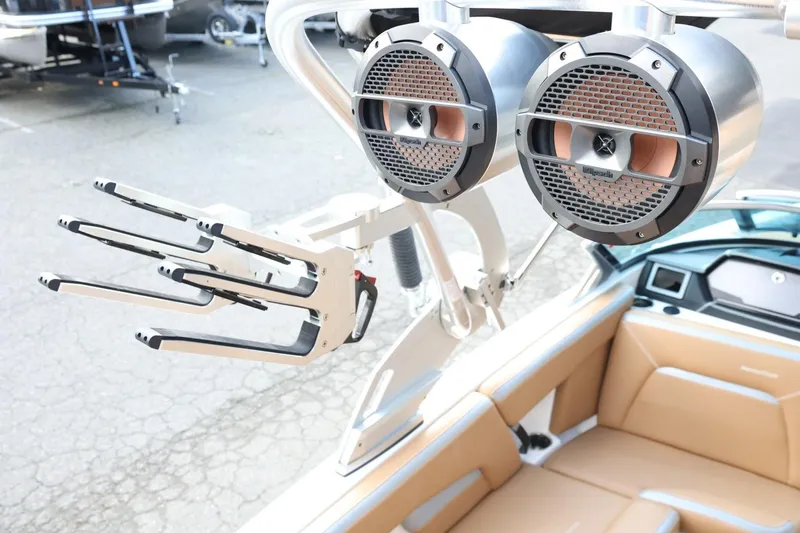 Slide: The Image of 2020 MasterCraft XStar boat with speakers and wakeboard rack, featuring tan interior. - 51