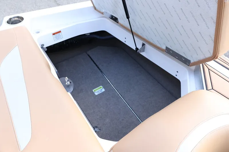 Slide: The Image of Open storage compartment in 2020 MasterCraft XStar boat with beige seating. - 54