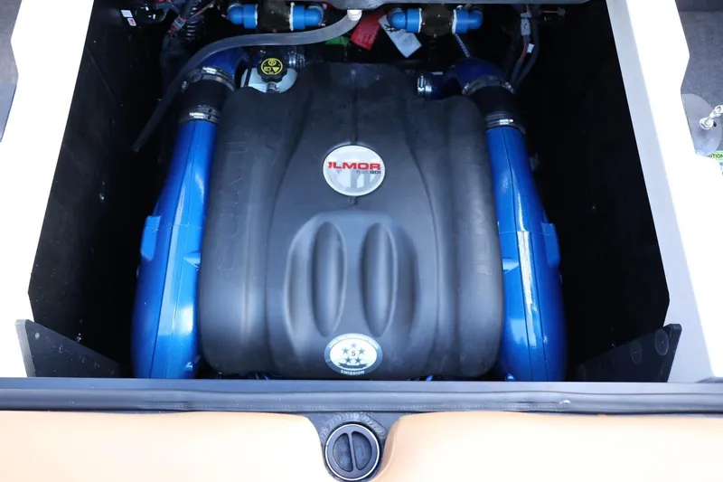 Slide: The Image of 2020 MasterCraft XStar engine compartment with Ilmor engine, featuring blue components. - 56