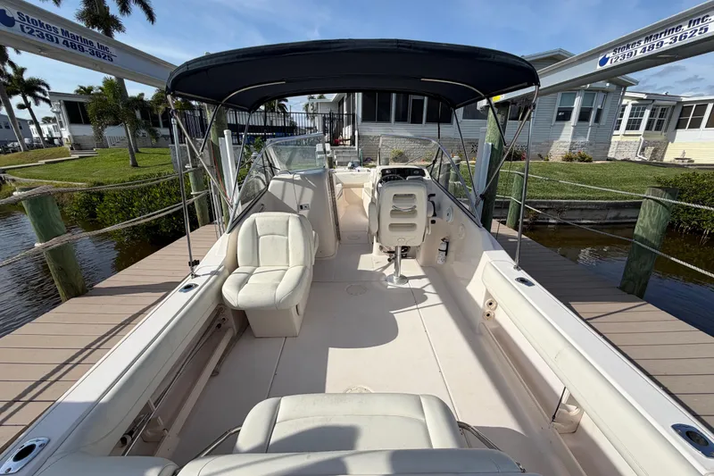 Slide: The Image of 2011 Grady-White Freedom 255 boat docked, featuring spacious seating and canopy. - 10
